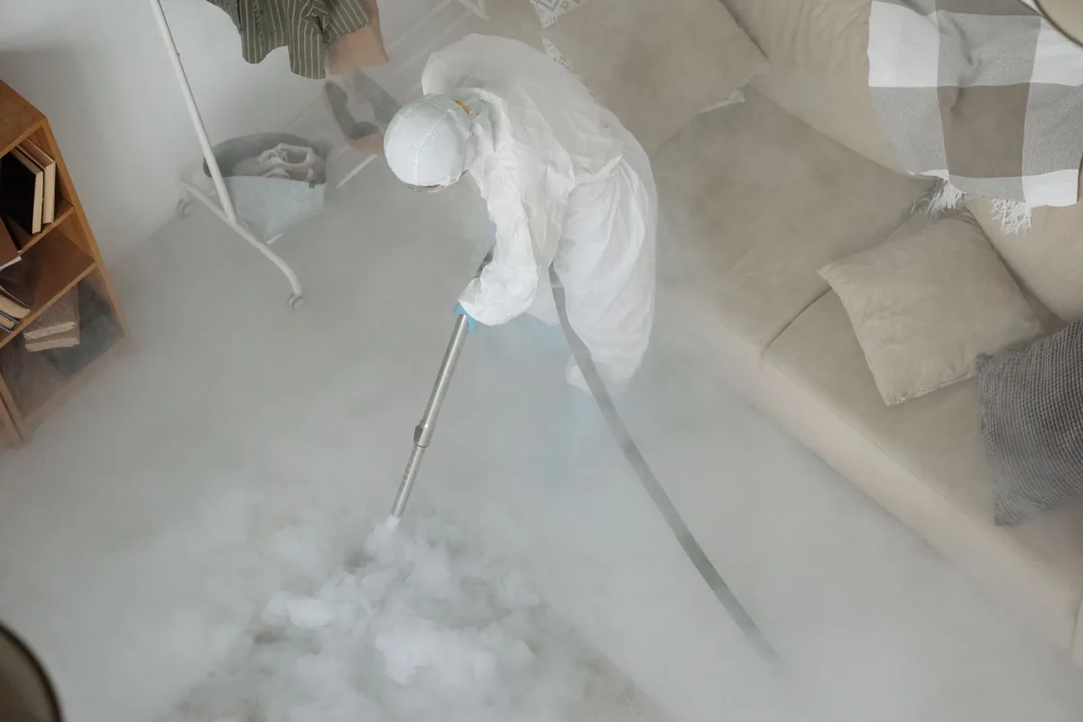Biohazard cleanup technician in protective equipment, Mena, AR